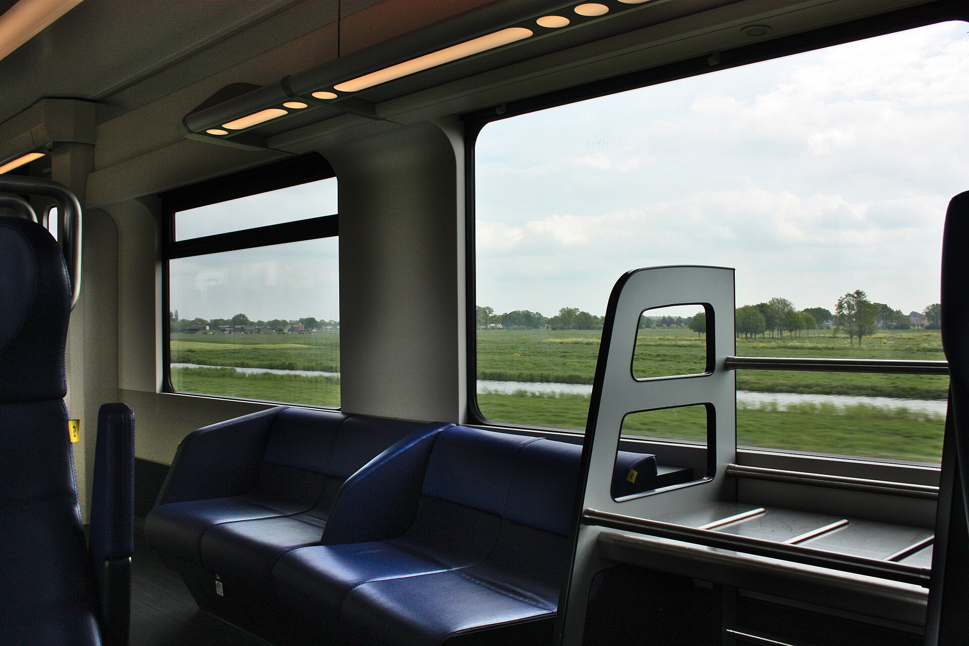 View from a moving NS train over the Dutch polder landscape